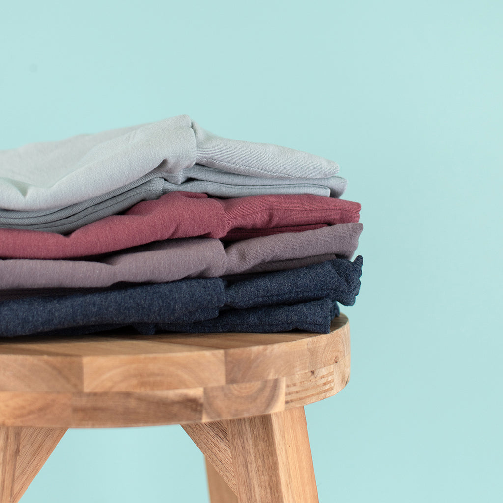A stack of harem pants in a variety of colours